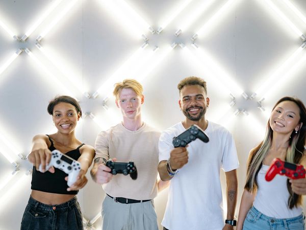 A group of diverse people smiling in a bright yoga studio.